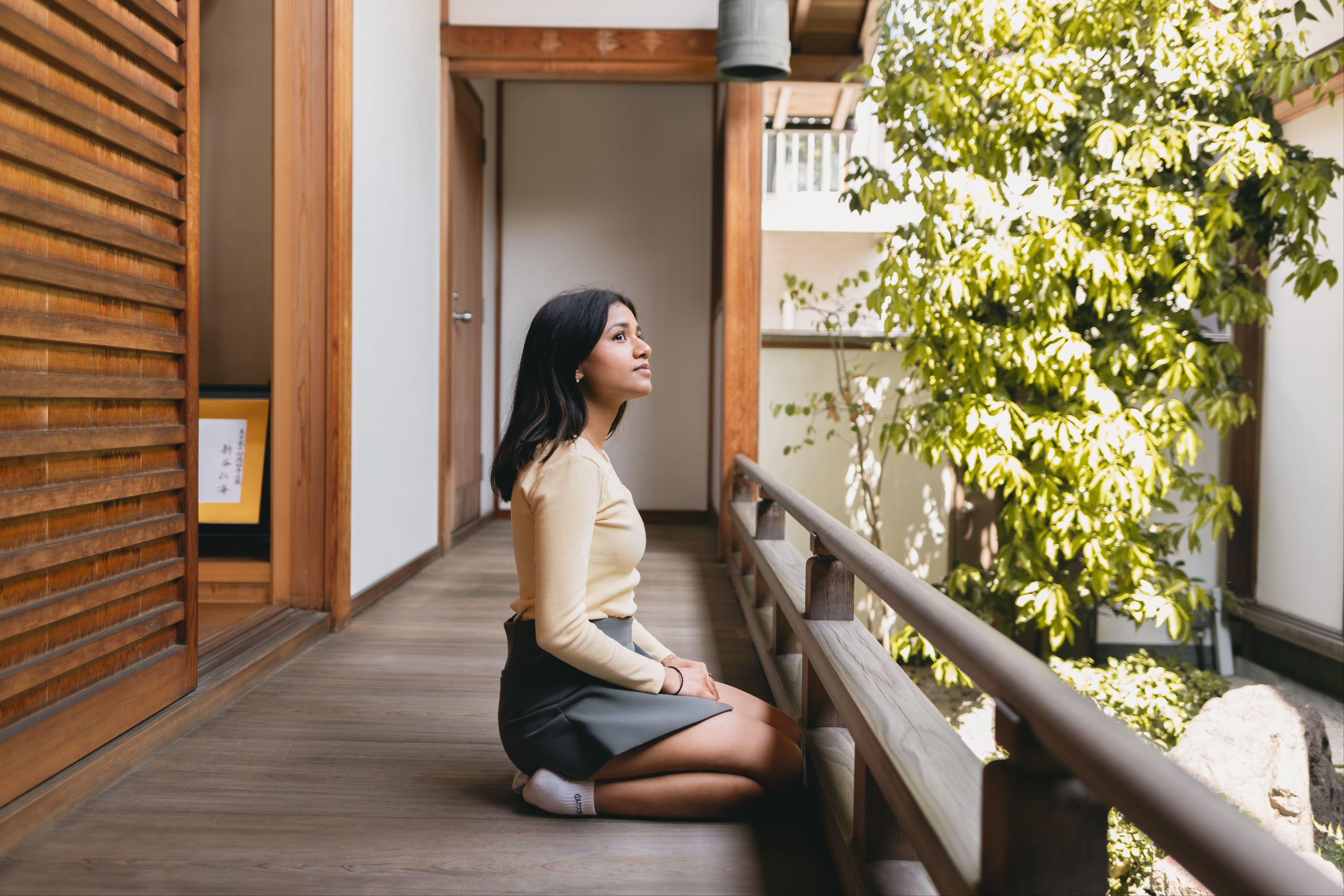 Ananya sitting in a traditional Japanese corridor