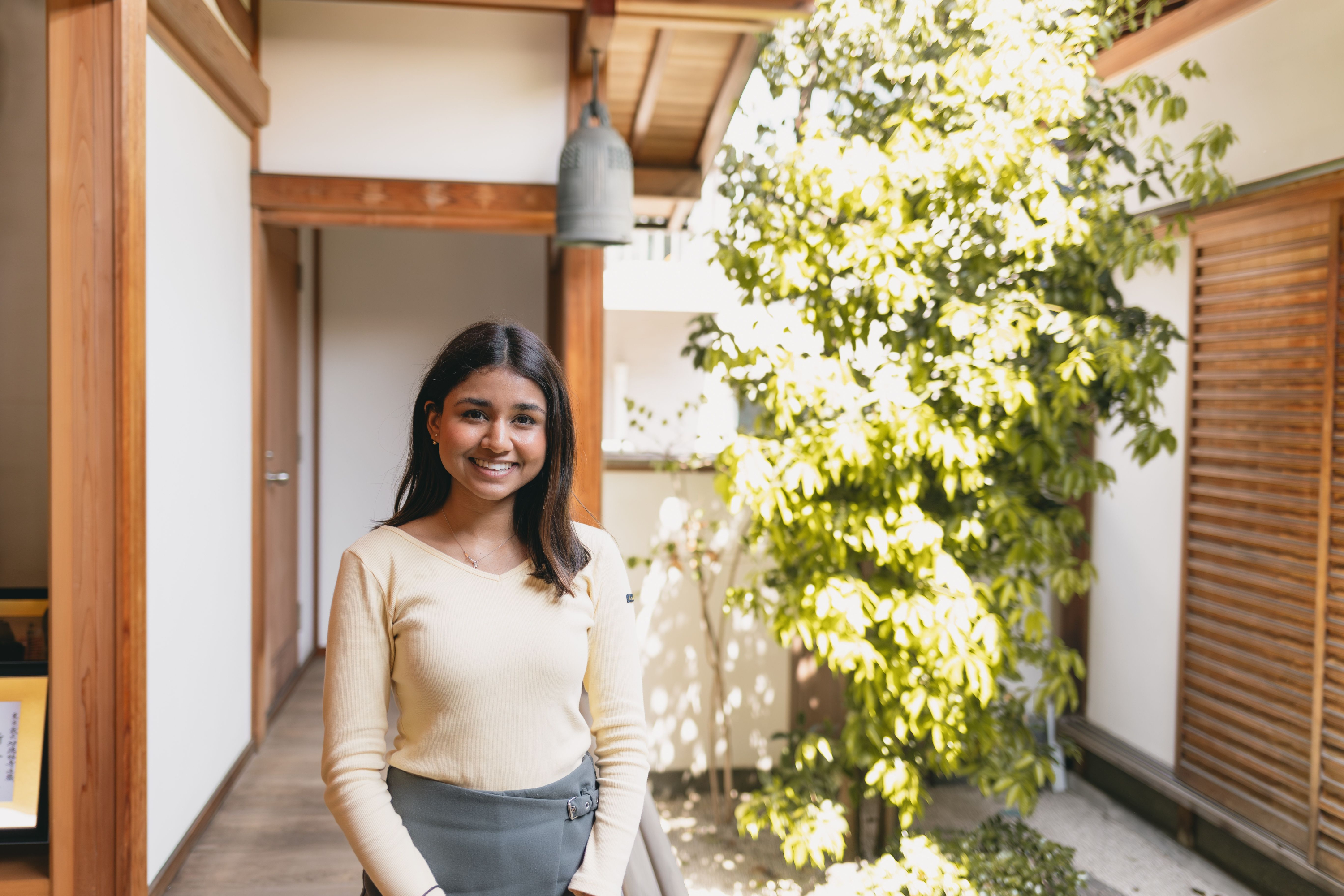 Ananya smiling in a sunlit Japanese interior